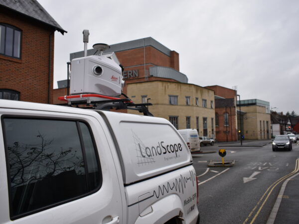 vehicle fitted with mobile mapping system driving through town centre