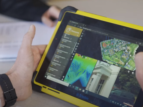close up of someone holding a tablet viewing data within orbit 3d mapping cloud