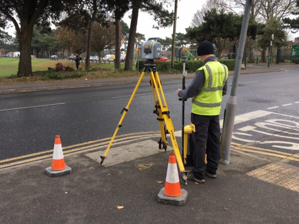 surveyor on roadside with trimble instrumentation for a topographical survey