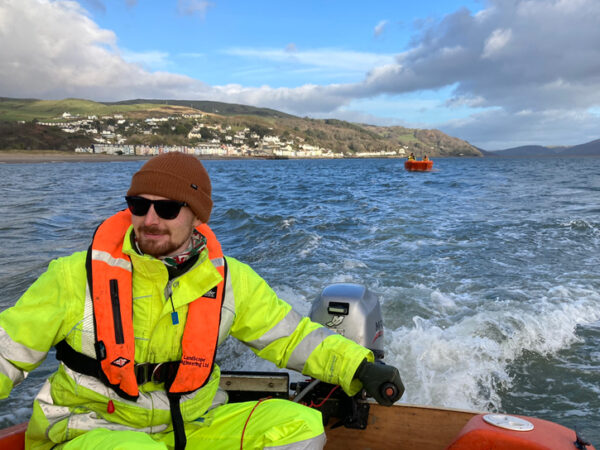 Engineer on a boat completing an underwater hydrogrpahic survey