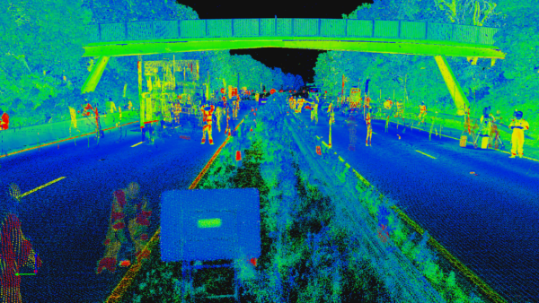 Surveying a bridge over a busy dual carriageway at night under traffic management
